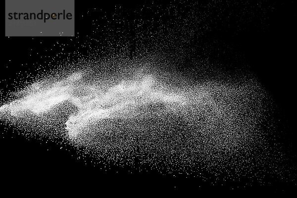 Bizarre forms of white powder explosion cloud against black background.White dust particles splash