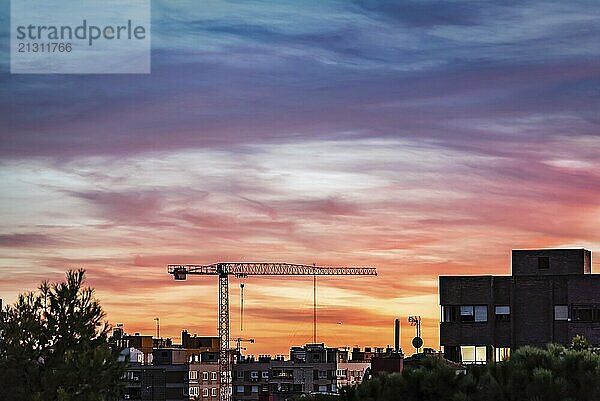 Construction crane on Madrid skyline at beautiful sunset