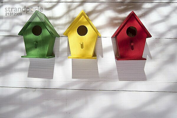 Small colorful houses for shelter birds hung on a wall