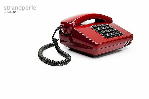 Classic red telephone from the eighties  against a white background