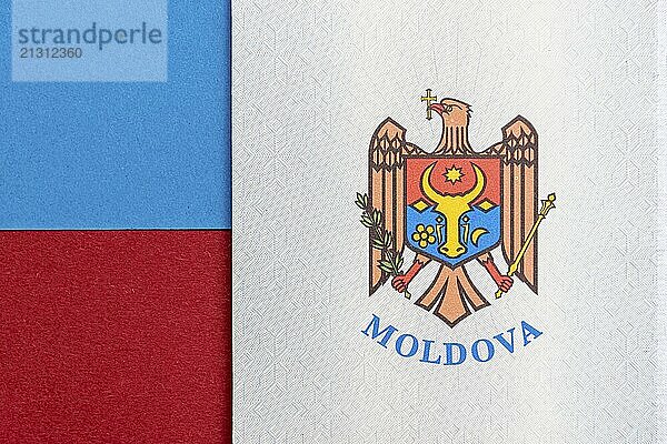 Republic of Moldova concept. The Moldovan passport on a blue and red background. Coloseup of the emblem/coat of arms of Moldova. Moldova Finance and economy concept