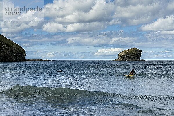 Portreath  United Kingdom  4 September  lifeguard riding a wave on her emergency rescue board at Portreath Beach in northern Cornwall  Europe