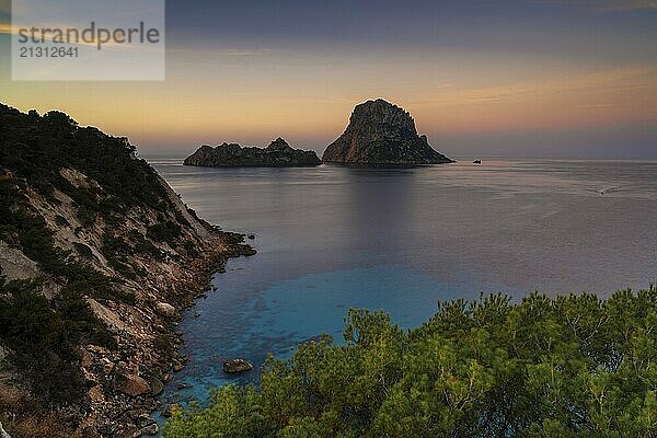 A view of the landmark Es Vedra island and rocks off the coast of Ibiza at sunrise