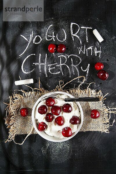 Presentation of desserts made with yogurt and cherries on a black background