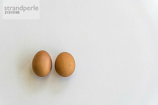 Top view of two eggs and isolated on white background with copy space