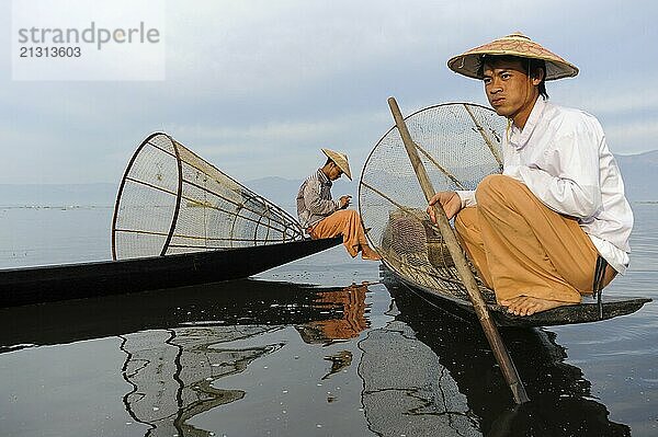 05.03.2014  Nyaung Shwe  Shan State  Myanmar  Asia  Two traditional fishermen on the northern shore of Inle Lake. The lake is located in Shan State in the centre of Myanmar  on the shores of which the Inthas live  living mainly from fishing and farming  Asia