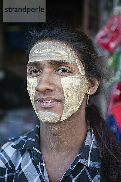 28.01.2017  Yangon  Myanmar  Asia  portrait of a young local man whose face is smeared with thanaka paste. Thanaka is a yellowish-white paste made from finely grated tree bark  also known as Burmese make-up  Asia