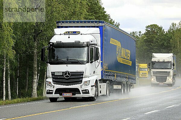 Raasepori  Finland. July 5  2019. Three semi trailer trucks transport cargo along wet highway 25 on a rainy day of summer in South of Finland