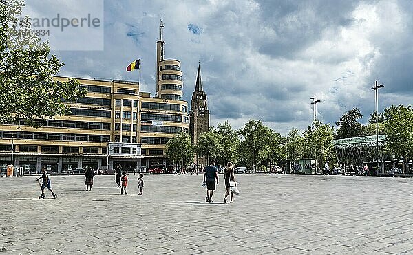 Belgium  06 16 2018: Mixed group of young people walking over the Flagey square with the concerthall in the background  Europe