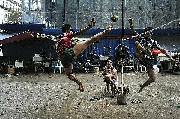 22.09.2013  Yangon  Myanmar  Asia  A group of men playing in a quiet side street in the city centre Takraw (Sepak Takraw)  Asia