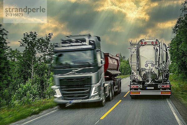 2 lorries  oncoming traffic  narrow road  European road E6  Trofors  Norway  public ground  Europe