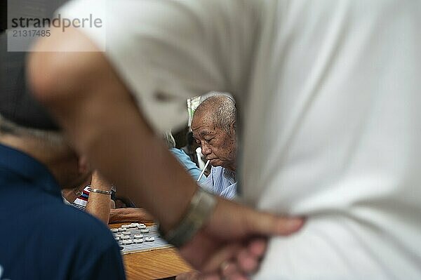 24.02.2019  Singapore  Republic of Singapore  Asia  Men play Chinese chess  also known as Xiangqi  next to the Buddha Tooth Relic Temple in the Chinatown district. Small amounts of money are often at stake  Asia