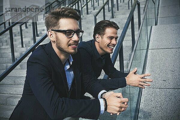 Two awesome businessman have a rest between a work. Speak easy