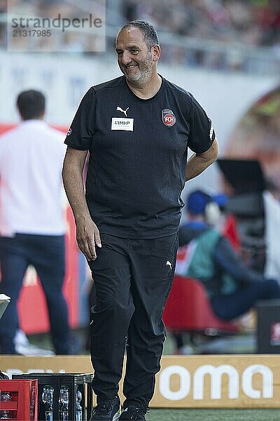 Football match  coach Frank SCHMIDT 1. FC Heidenheim laughs to the left in the direction of the coaches' bench  Voith-Arena football stadium  Heidenheim