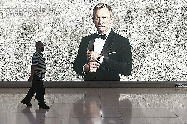 12.03.2020  Singapore  Republic of Singapore  Asia  A man walks past an advertising space for the new James Bond film wearing a mask to protect himself from infection with the pandemic coronavirus  Asia