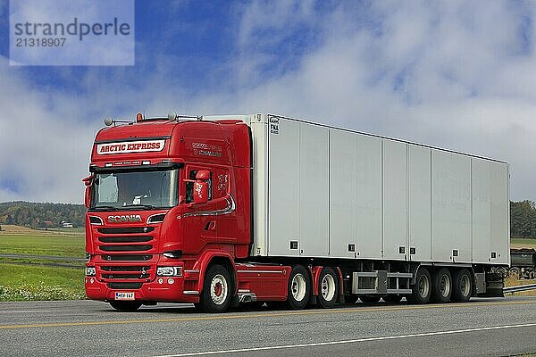 Red Scania truck of Arctic Express pulling FNA temperature controlled semi trailer on highway 52 in Salo  Finland. September 26  2020