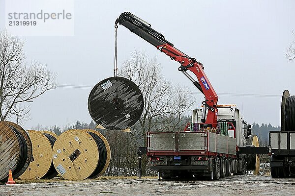 SALO  FINLAND  FEBRUARY 17  2017: Truck mounted crane unloads power cable drums on undergrounding work site. In the area overhead cables will be replaced with underground cables