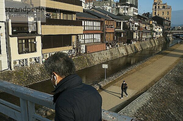 26.12.2017  Kyoto  Japan  Asia  A man crosses a bridge over the Kamo River in Kyoto early in the morning  Asia