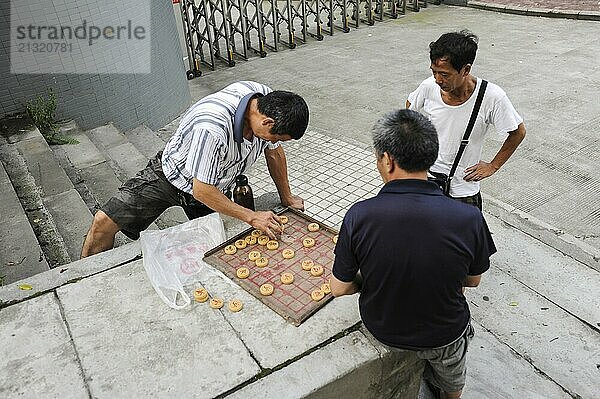 01.08.2012  Chongqing  China  Asia  Men playing Chinese chess  also called Xiangqi  Asia