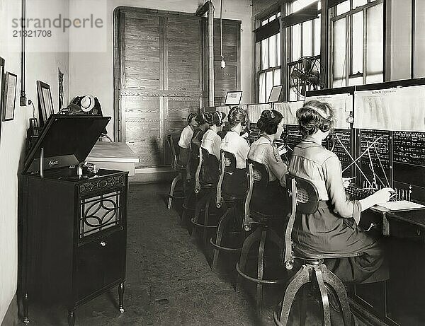 Switchboard operators listening to the Edison‘s phonograph  1919  digitally edited