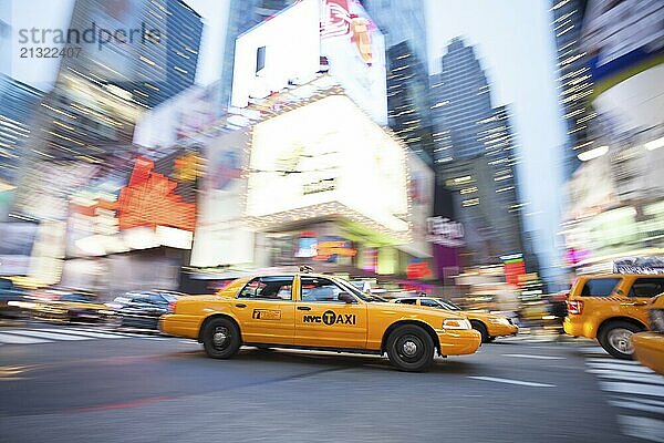 Panning image of a Yellow Taxi cab in Times Square  New York City. New York. USA