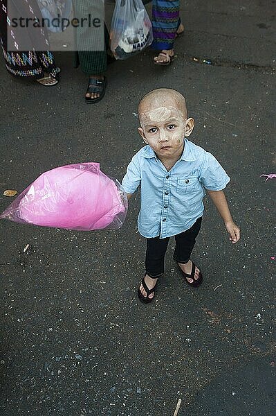 28.01.2017  Yangon  Republic of the Union of Myanmar  Asia  A little boy holds a candyfloss in his hand at a street festival