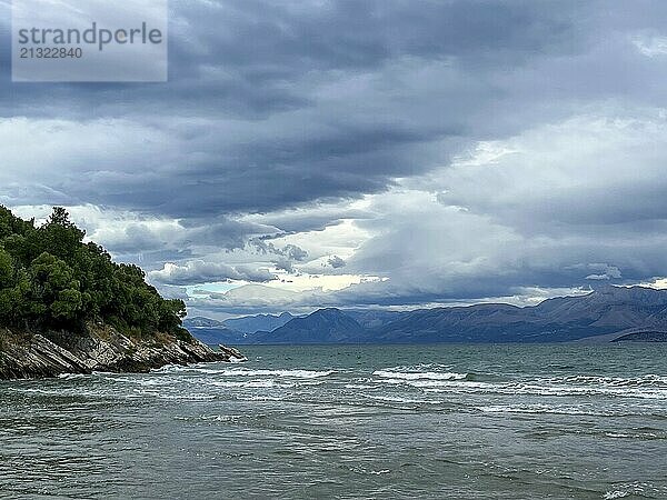 Kalamaki  Corfu  Greece  View from Kalamaki beach in the north-east of the Greek island of Corfu over the Ionian Sea towards the mainland of Albania near the town of Saranda  Europe