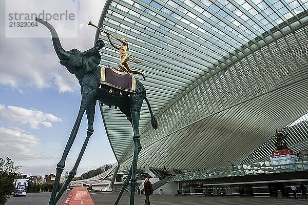 4-19-2016 Liege BELG Salvador Dali sculture  elephant and boy from above next to the futuristic with transparent roof Liege train station