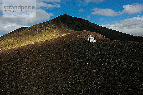 Wedding couple against mountains in Iceland