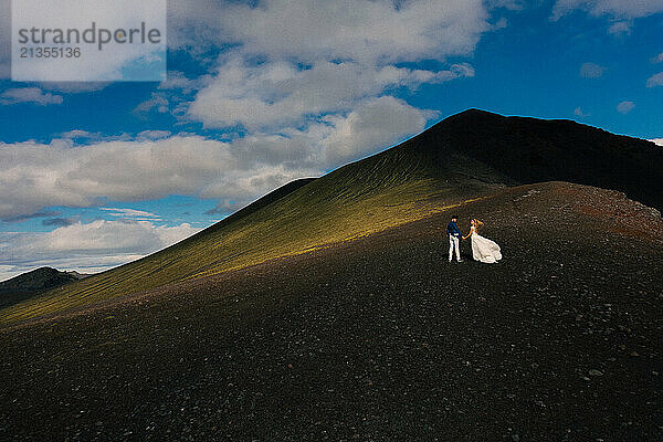 Wedding couple against mountains in Iceland