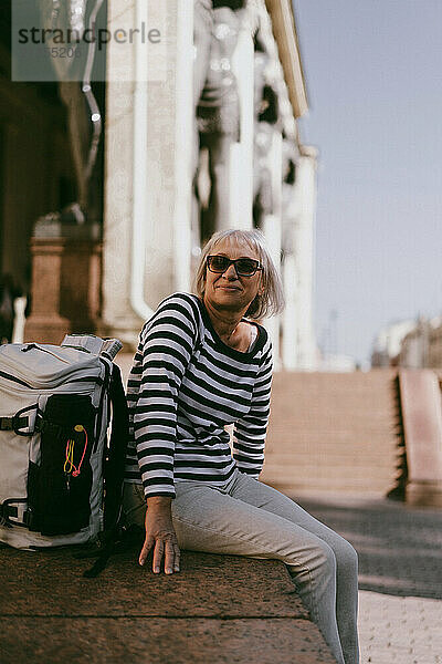 A middle-aged woman travels with a backpack