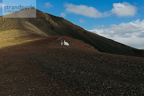 Wedding couple against mountains in Iceland