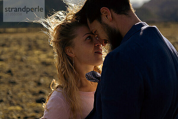 The groom kisses the bride in the mountains of Iceland.