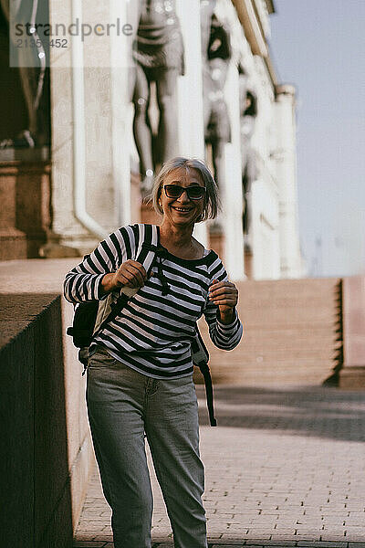 A middle-aged woman travels with a backpack