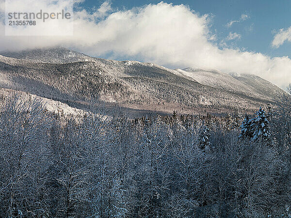 Early winter snow articulates the Bigelow Range from Sugarloaf Mountain in Carrabassett Valley  Maine.