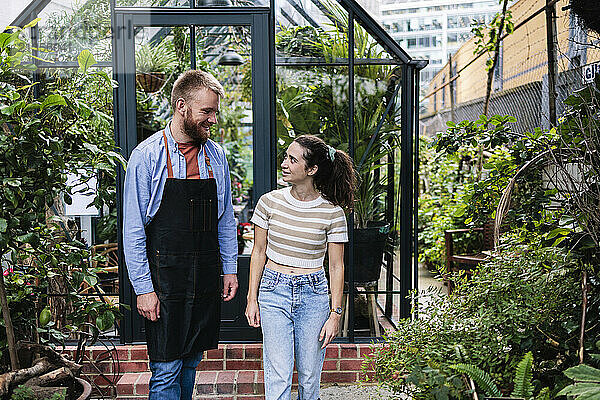 Couple walking with each other outside greenhouse