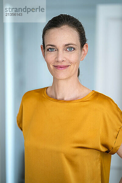 Smiling mature woman wearing yellow t-shirt