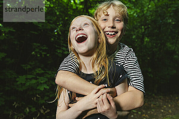 Laughing hugging brother and sister  Hamburg  Germany