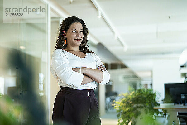 Confident businesswoman standing in office