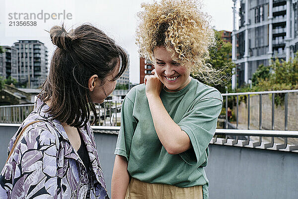 Happy lesbian couple enjoying in front of building