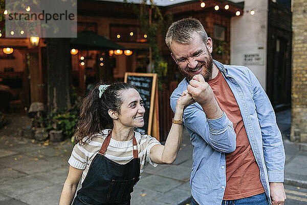 Carefree couple enjoying leisure time outside coffee shop