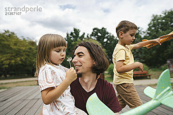 Mature man with son and daughter in park