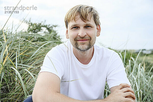 Smiling mature man in meadow