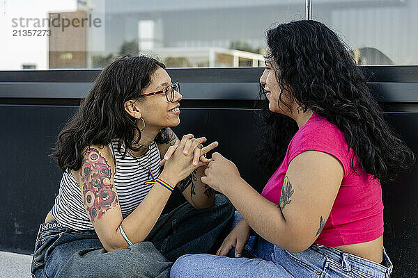 Lesbian couple sitting talking with each other