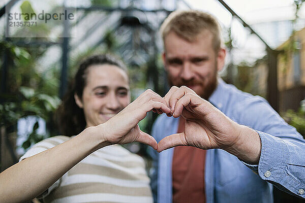 Couple making heart shape with hands