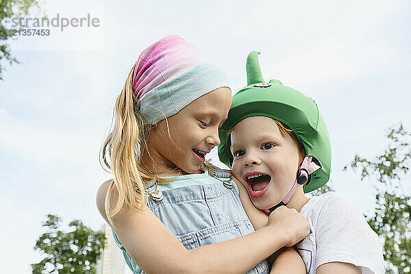 Happy brother and sister in park