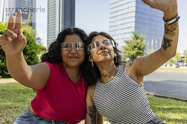 Happy gay couple wearing smart glasses at park