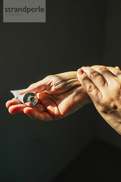 Woman applying cream on hands