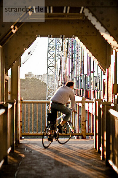 A cyclist passes through one of the bridge spans of the George Washington Bridge on Monday afternoon.