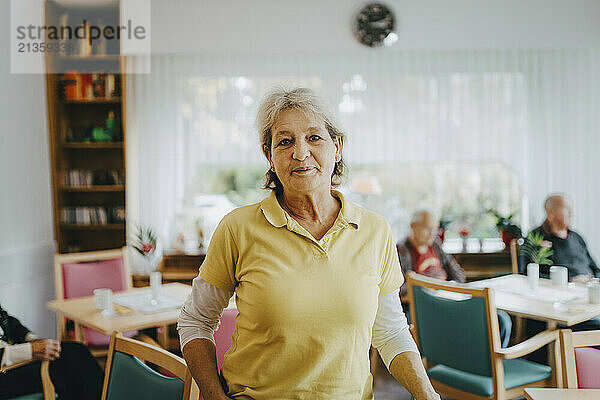 Portrait of confident female nurse at retirement home